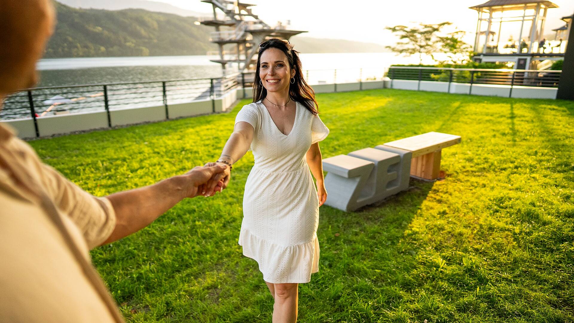 Pärchen steht händchenhaltend bei der Zeitbank in Millstatt