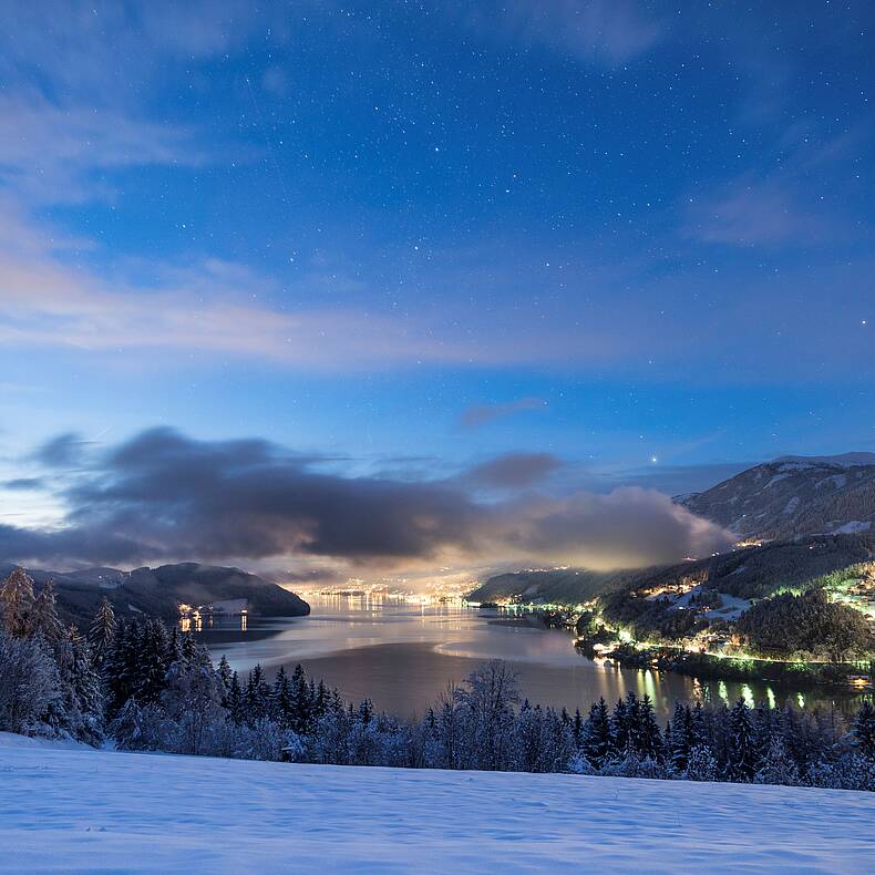 Besinnliche Aussicht über den Millstätter See im Winter in der Abenddämmerung